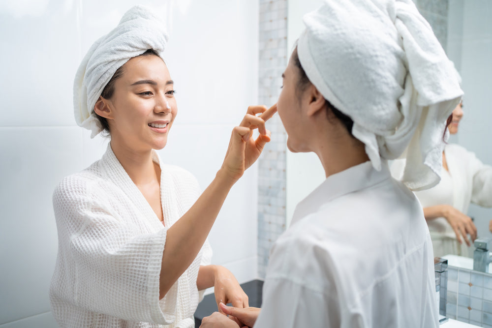 two women in robes doing skincare